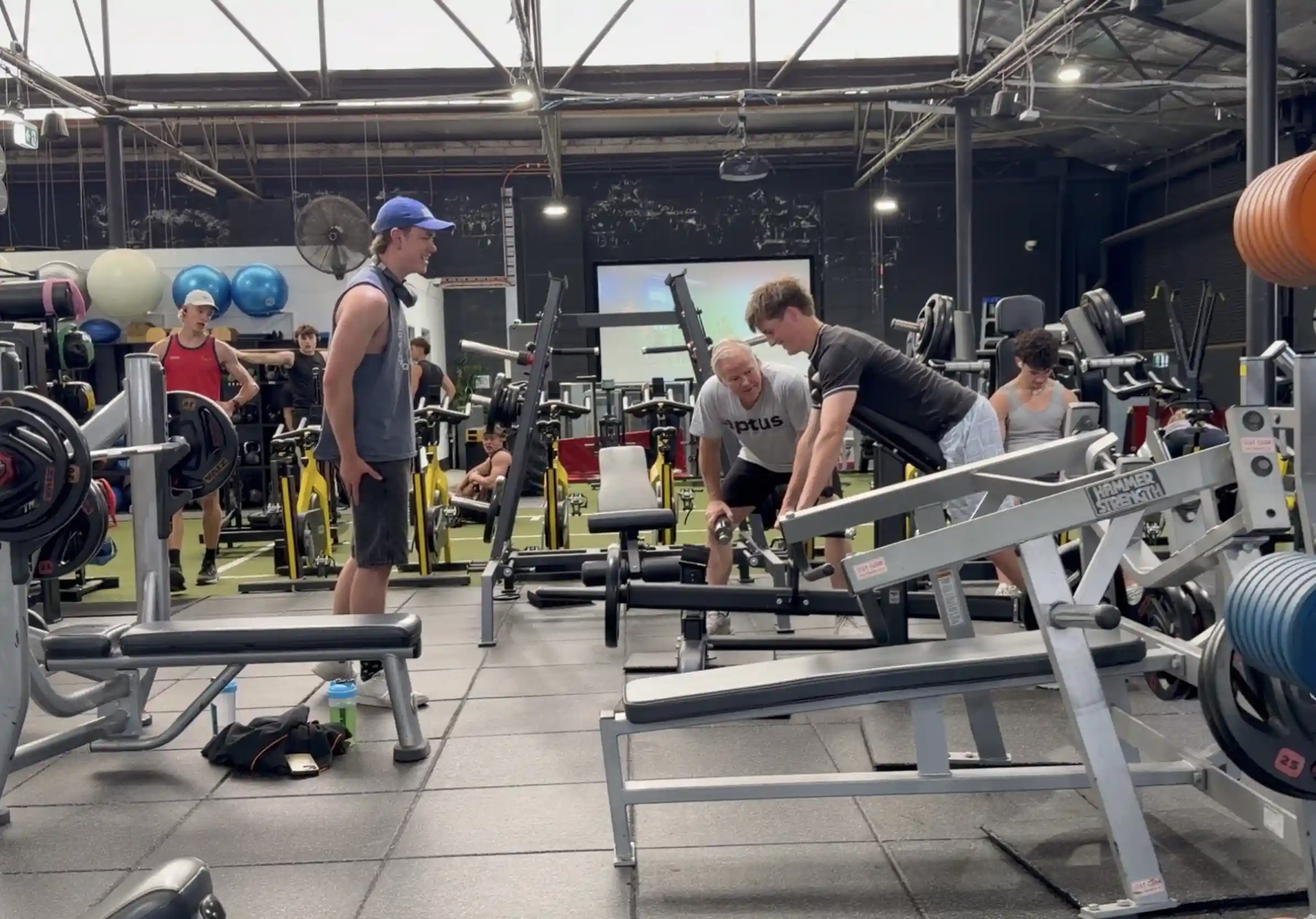 Premium strength training area at Aptus Health Club Camberwell featuring Hammer Strength machines, selectorized equipment and dedicated stretching zone